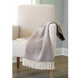 Dotted throw blanked with woven fringe.