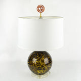 Script monogram lamp finial in tortoise displayed on a lamp