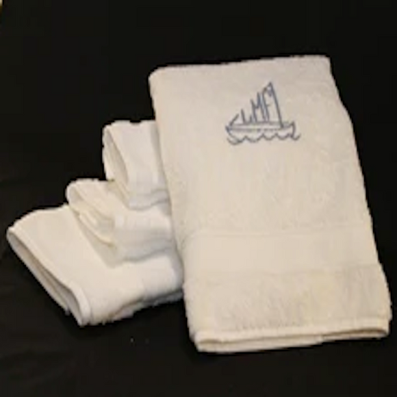 Set of white premium bath towels with slate blue sailboat monogram