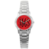 Watch with red background and black script monogram