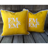 Sunbrella® pillows with white rope welt and matching white monogram