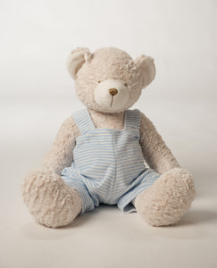 Child with teddy bear wearing grey striped overalls with a grey monogram.