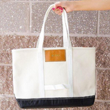 Canvas tote with black base and gold stamped monogram