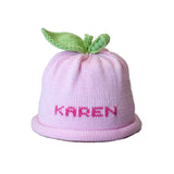 Pink child's personalized knitted hat with sweet pea