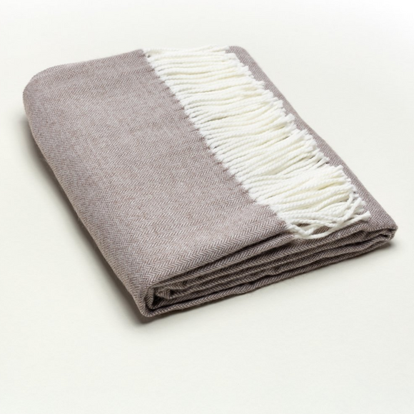 Taupe throw blanket with fringe.