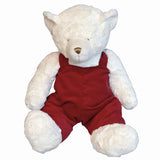 White teddy bear with red overalls.