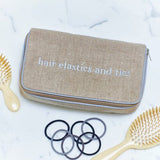 Natural textured linen double hand embroidered jewelry case with grey piping and grey typewriter text