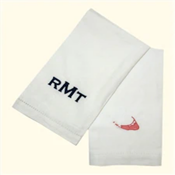 Linen hem stitch guest towels. monogram shown left to right: navy copperplate monogram and island red island